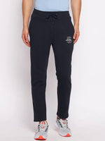 Wearing 98degreenorth Men’s Navy Fleece Trackpants, paired with gray sneakers with orange accents.