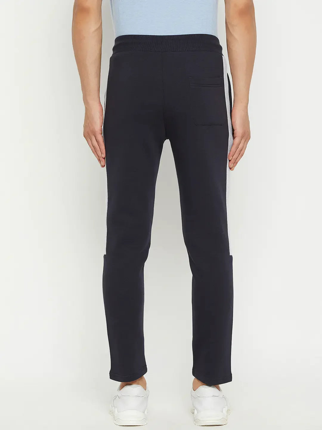 Man in 98degreenorth Men’s Navy Fleece Trackpants with Contrast Side Stripe, shown from the back on a white background.