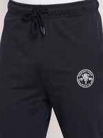 Close-up of 98degreenorth Men's Navy French Terry Lycra Trackpants featuring a white logo and drawstring waistband.