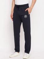 Man in 98degreenorth Men's Navy French Terry Lycra Trackpants, white sneakers, and classic white tee.