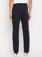 Man in 98degreenorth Men's Navy French Terry Lycra Trackpants & white sneakers, shown from the back against plain backdrop.