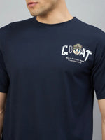 Man in 98degreenorth navy oversized tee with GOAT and dog in sunglasses and hat graphic on the chest.