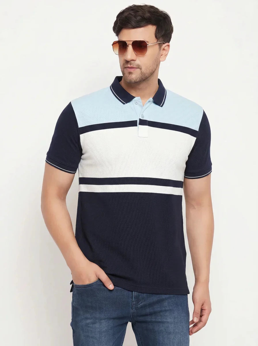 Man in 98degreenorth Men's Navy Sky Blue Colour Block Polo T-Shirt—Pique Knit, sunglasses, and blue jeans.