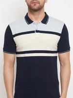 Man wears the 98degreenorth Men's Navy Sky Blue Colour Block Pique Polo T-Shirt with a classic pique knit design.