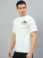 Man in 98degreenorth Men's Off-White Graphic Oversized T-Shirt with GOAT Back Print, against a gray background.