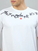 Man wears 98degreenorth Off-White Oversized Tee with "They Made Me Do It" back print near the collar.