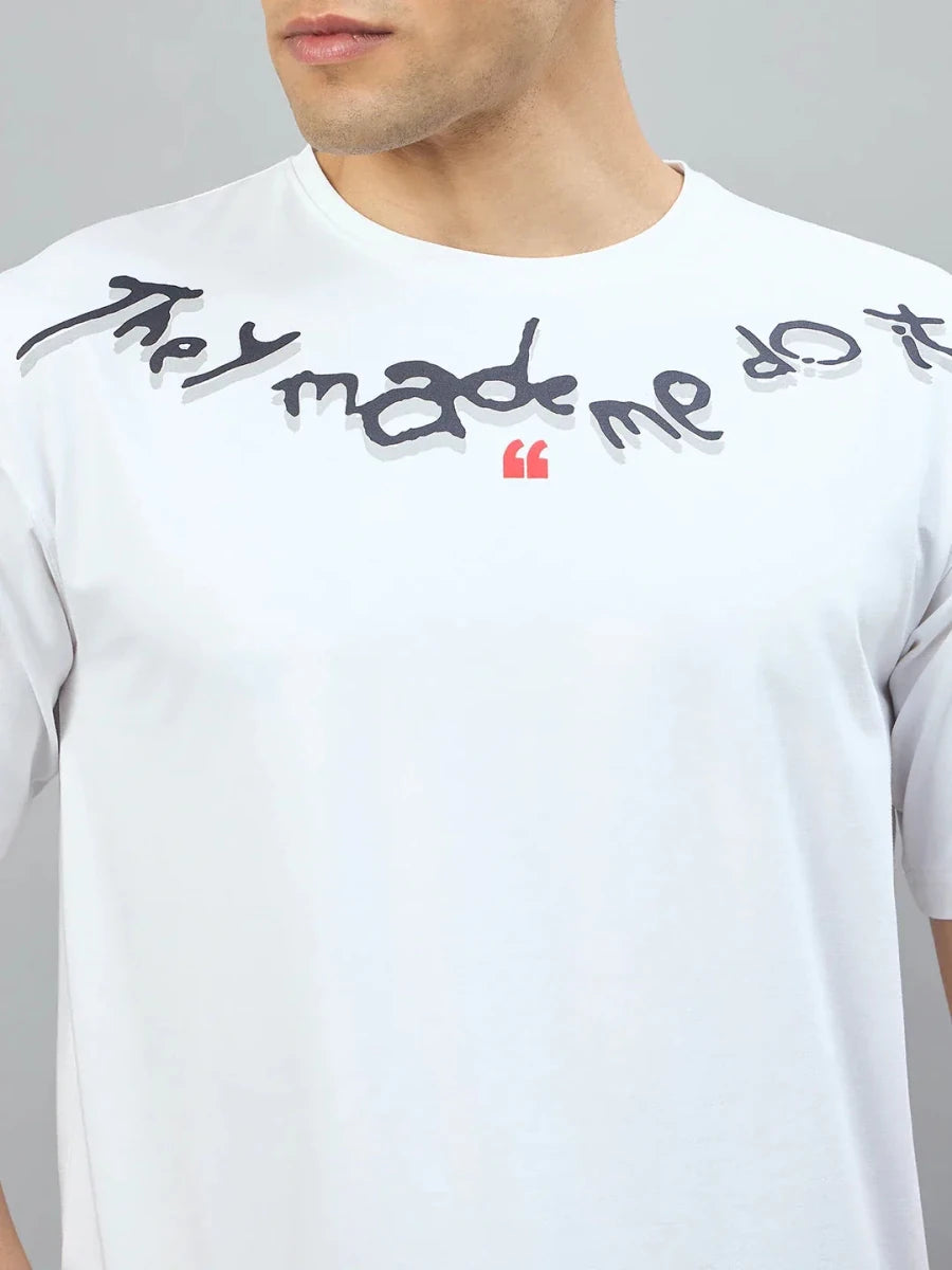 Man wears 98degreenorth Off-White Oversized Tee with "They Made Me Do It" back print near the collar.