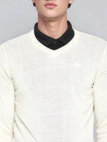 A man wears the 98degreenorth Men’s Off-White Merino Wool V-Neck Sweater over a black collared shirt, shoulder to lips.