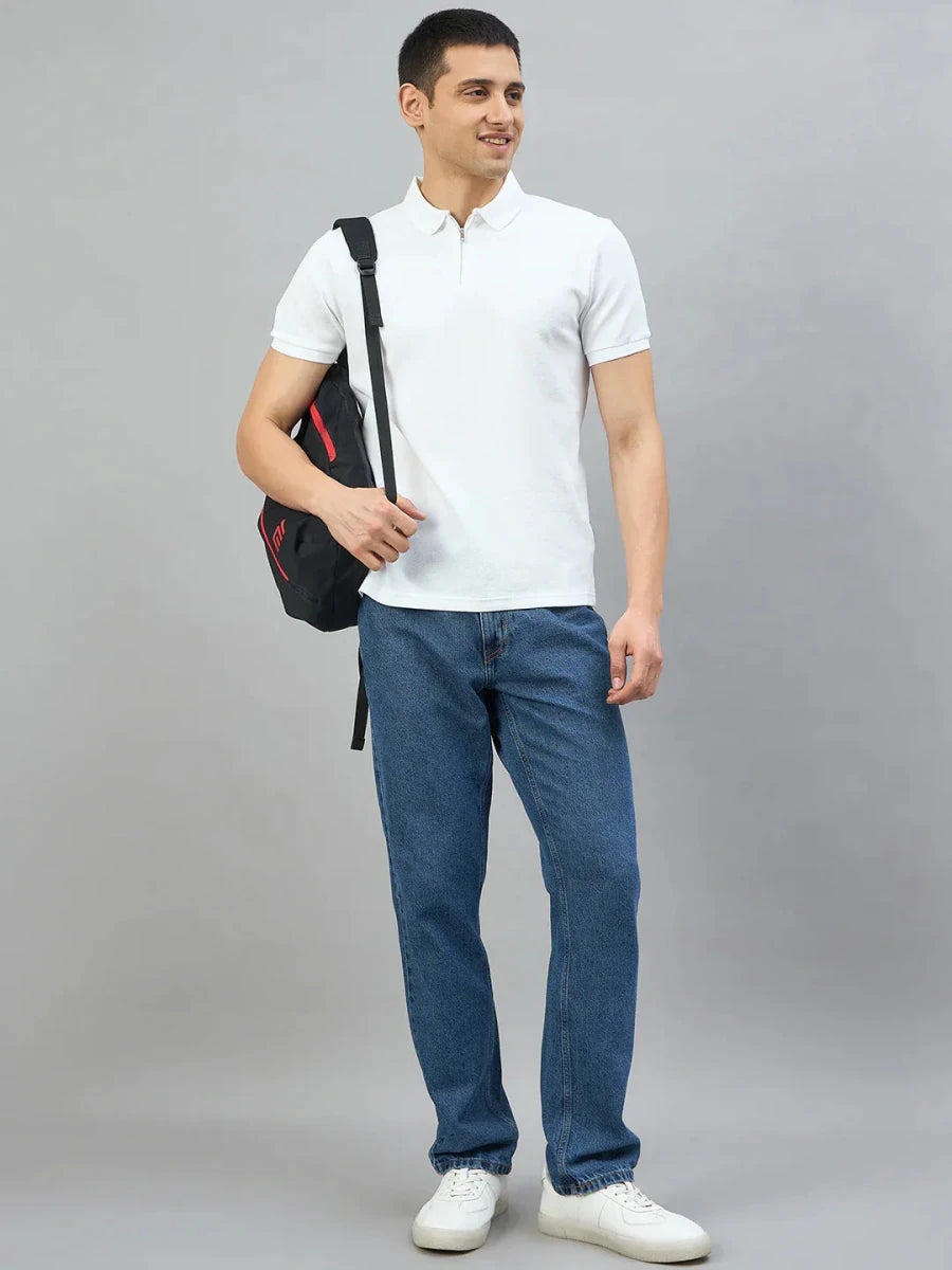 Man wears 98degreenorth Off-White Quarter Zip Polo T-Shirt (Popcorn Knit), blue jeans, white sneakers, and smiles with a black backpack.