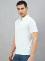 Man wearing a 98degreenorth Men's Off-White Quarter Zip Polo T-Shirt (Popcorn Knit) and blue jeans against gray background.