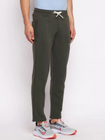 Man wears 98degreenorth Men’s Olive Fleece Trackpants, soft brushed joggers, against a plain white background.