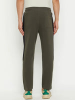 A person wearing 98degreenorth Men’s Olive Fleece Trackpants with black side panel, viewed from the back.