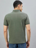 Man wearing 98degreenorth Men's Olive Green Quarter Zip Polo T-Shirt—Popcorn Knit, seen from the back with blue jeans.