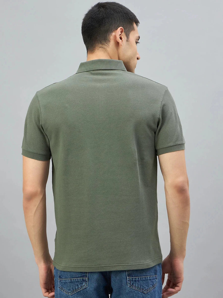 Man wearing 98degreenorth Men's Olive Green Quarter Zip Polo T-Shirt—Popcorn Knit, seen from the back with blue jeans.
