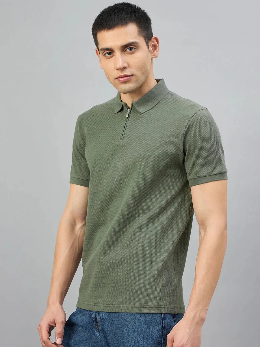 Man wears 98° North Olive Green Quarter Zip Polo T-Shirt, Popcorn Knit, standing against a plain grey background.