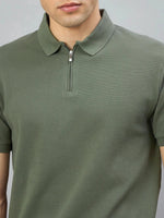 Man wears the 98° North Olive Green Quarter Zip Polo T-Shirt, Popcorn Knit, shown from shoulders to mid-chest.