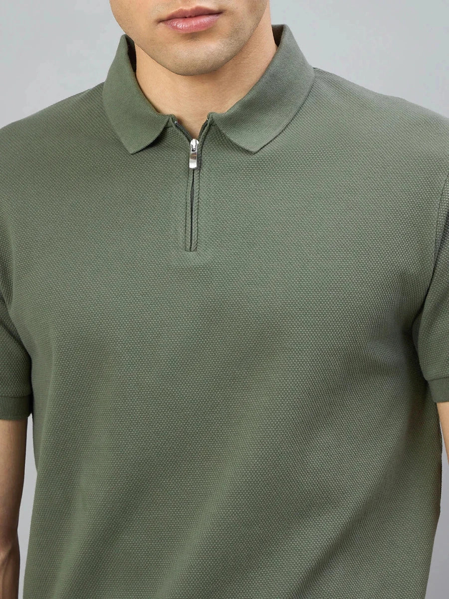 Man wears the 98° North Olive Green Quarter Zip Polo T-Shirt, Popcorn Knit, shown from shoulders to mid-chest.
