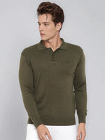 Man wears 98degreenorth Men’s Olive Merino Wool Polo Neck Sweater with white pants, looking left against gray background.