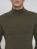 A man in a 98degreenorth olive merino wool turtleneck sweater with a small chest logo.