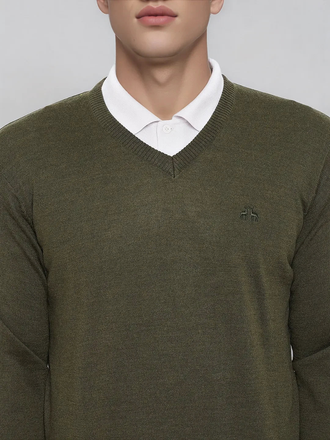 Man wearing a 98degreenorth Olive Merino Wool V-Neck Sweater over a white shirt against a plain background.