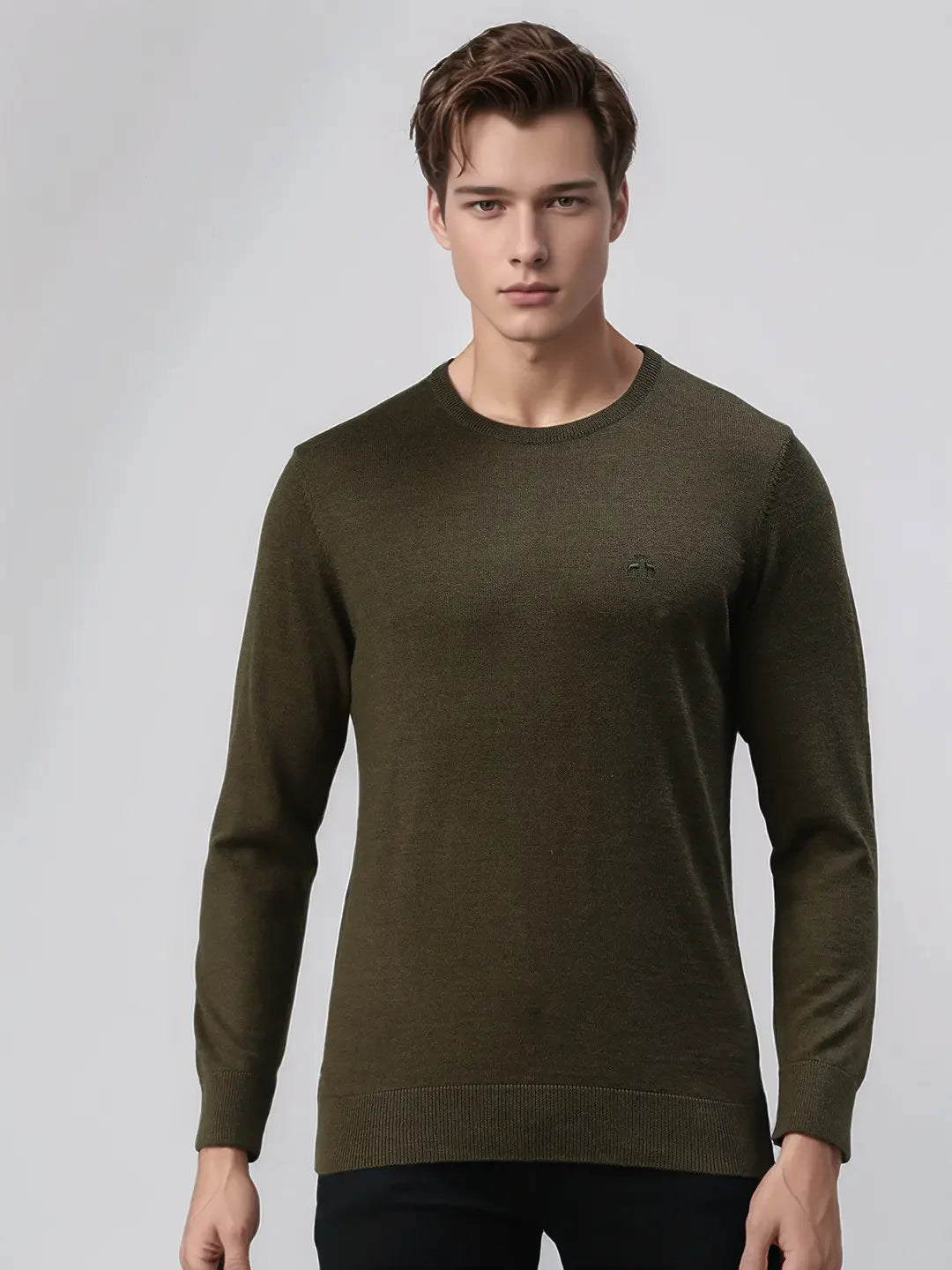 A man wears the 98degreenorth Men’s Olive Premium Merino Wool Round Neck Sweater against a light gray background.