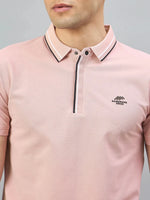 Man in 98degreenorth Men's Pink Polo — Handmade Series with black & white contrast tipping and chest logo.