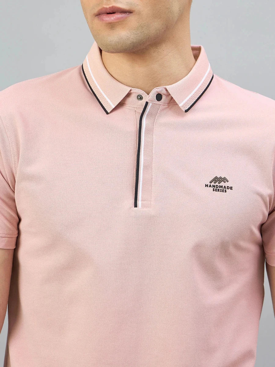Man in 98degreenorth Men's Pink Polo — Handmade Series with black & white contrast tipping and chest logo.