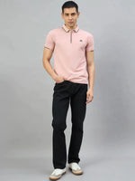 Man in black jeans and white sneakers wears 98degreenorth Men's Pink Polo T-Shirt—Handmade Series, Contrast Tipping.