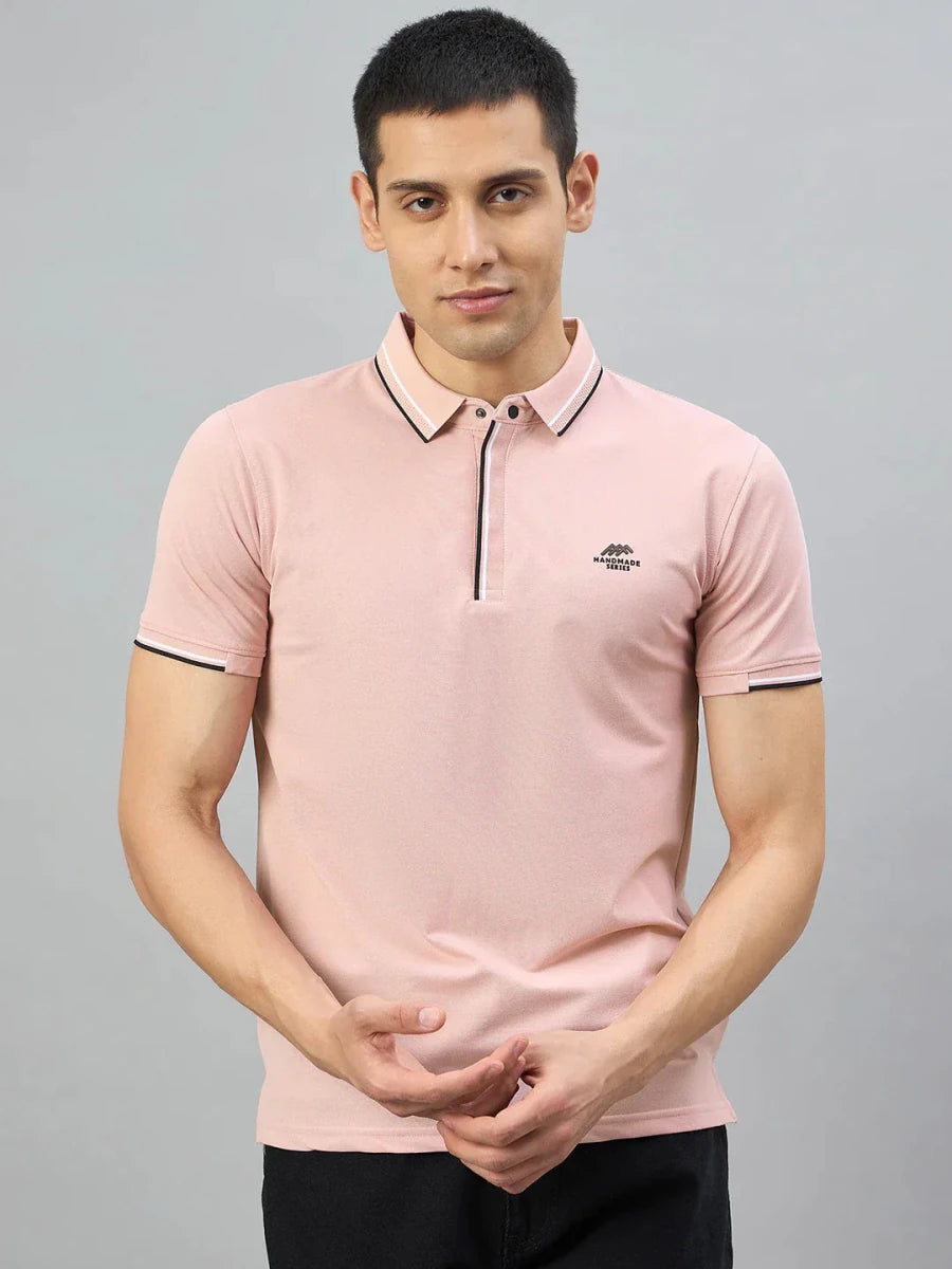 Man wearing a 98degreenorth Men's Pink Polo T-Shirt — Handmade Series with contrast tipping, on a plain gray background.