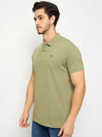 A man in a 98degreenorth Men's Pista Green Polo T-Shirt stands against a plain white background.