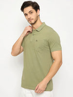 Man wears 98degreenorth Men's Pista Green Polo—pure cotton pique with chest pocket—against a white background.