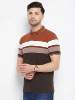 Man in 98degreenorth's rust brown striped colour block polo T-shirt with blue jeans, on a plain white background.