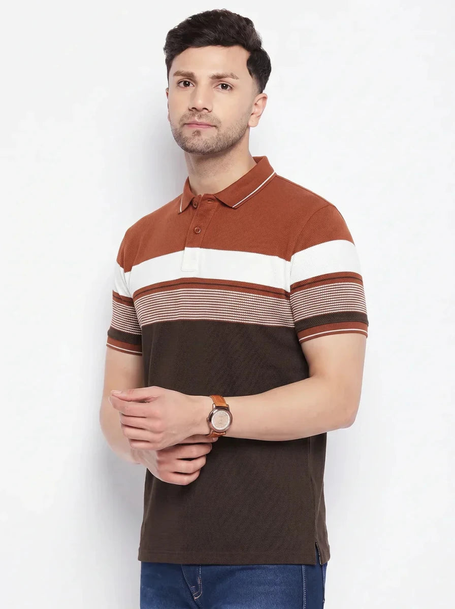 Man in 98degreenorth's rust brown striped colour block polo T-shirt with blue jeans, on a plain white background.