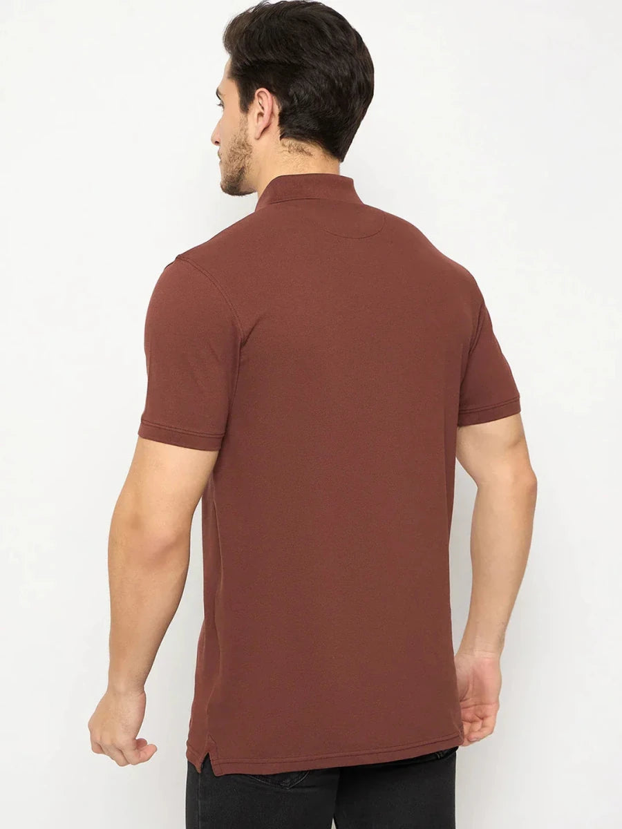 Man wears 98degreenorth Men's Rust Solid Polo T-Shirt—Cotton Pique, black pants, back to camera, on white background.