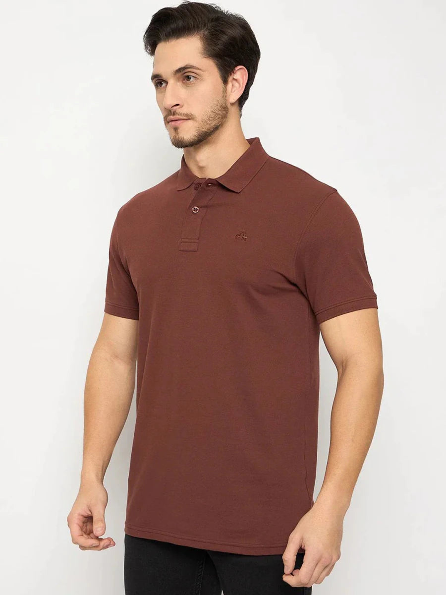 Man wearing a 98degreenorth Men's Rust Solid Polo T-Shirt, Cotton Pique, with black pants against a white background.