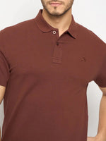 Man wears 98degreenorth Men's Rust Solid Polo—regular fit cotton pique with small logo on left chest.