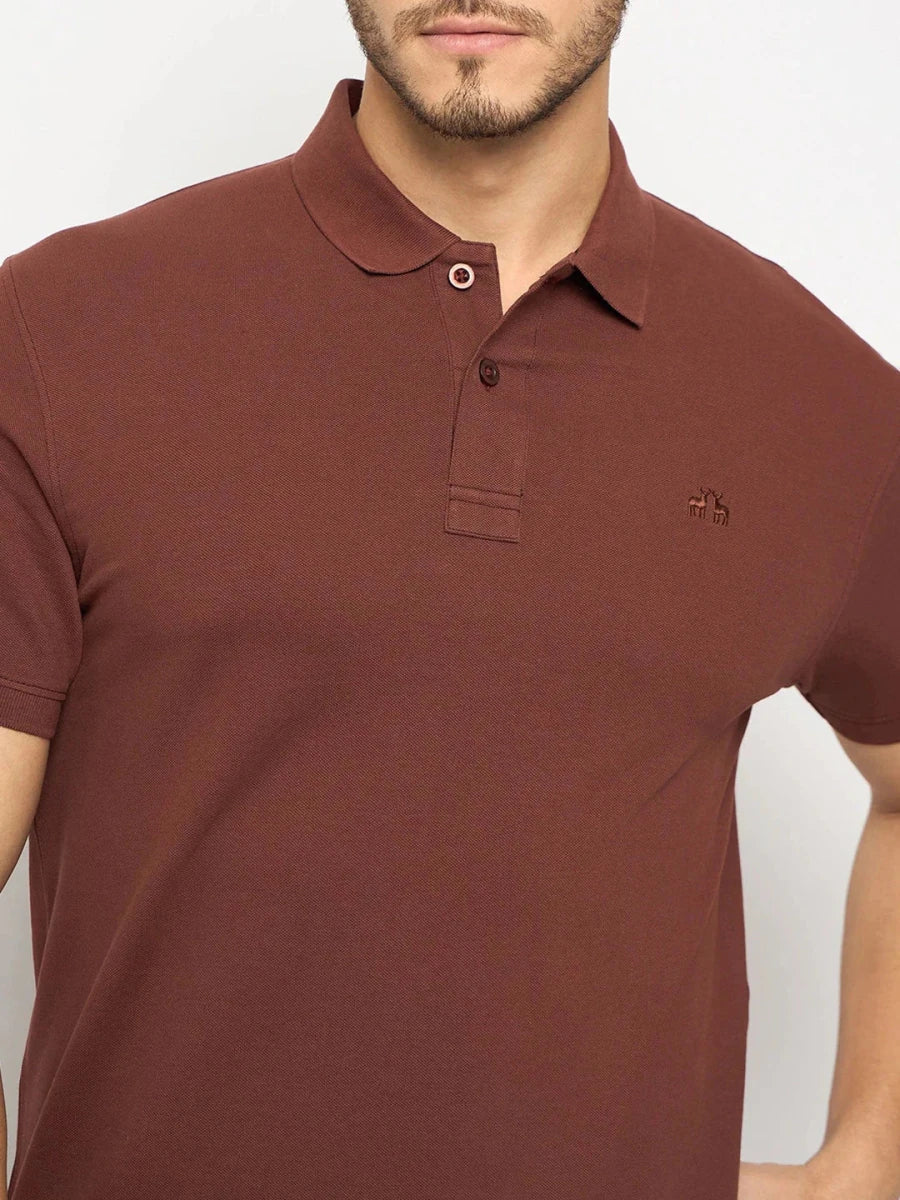 Man wears 98degreenorth Men's Rust Solid Polo—regular fit cotton pique with small logo on left chest.