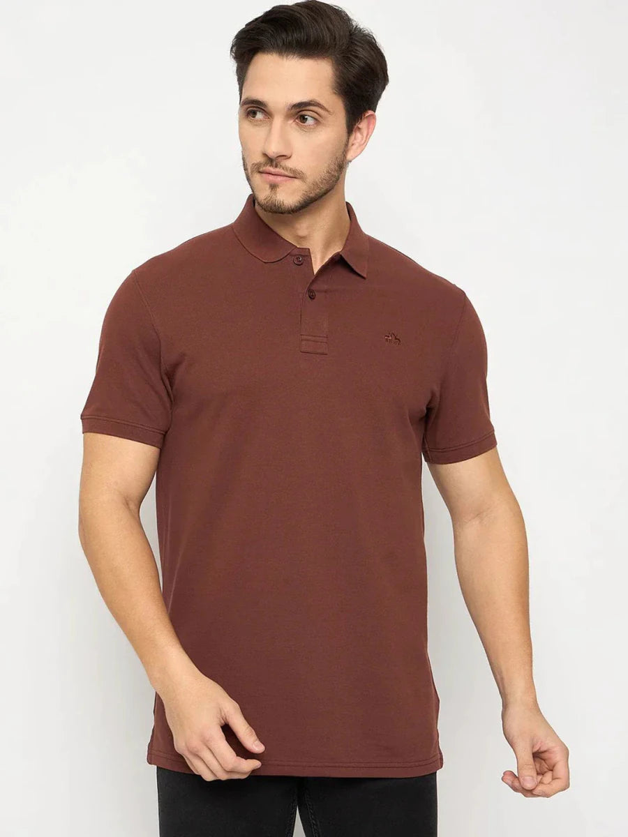 Man in 98degreenorth Men's Rust Solid Polo T-Shirt—Cotton Pique, paired with black pants, on white background.