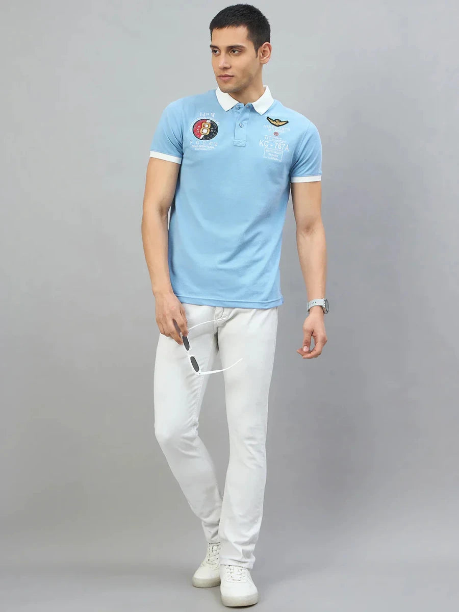 Man wears a Men's Sky Blue Aeronorth KC-767A Aviation Polo T-Shirt by 98degreenorth—ideal for aviation enthusiasts.