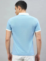 Man wears the 98degreenorth Men's Sky Blue Aeronorth KC-767A Aviation Polo T-Shirt—ideal for aviation enthusiasts.