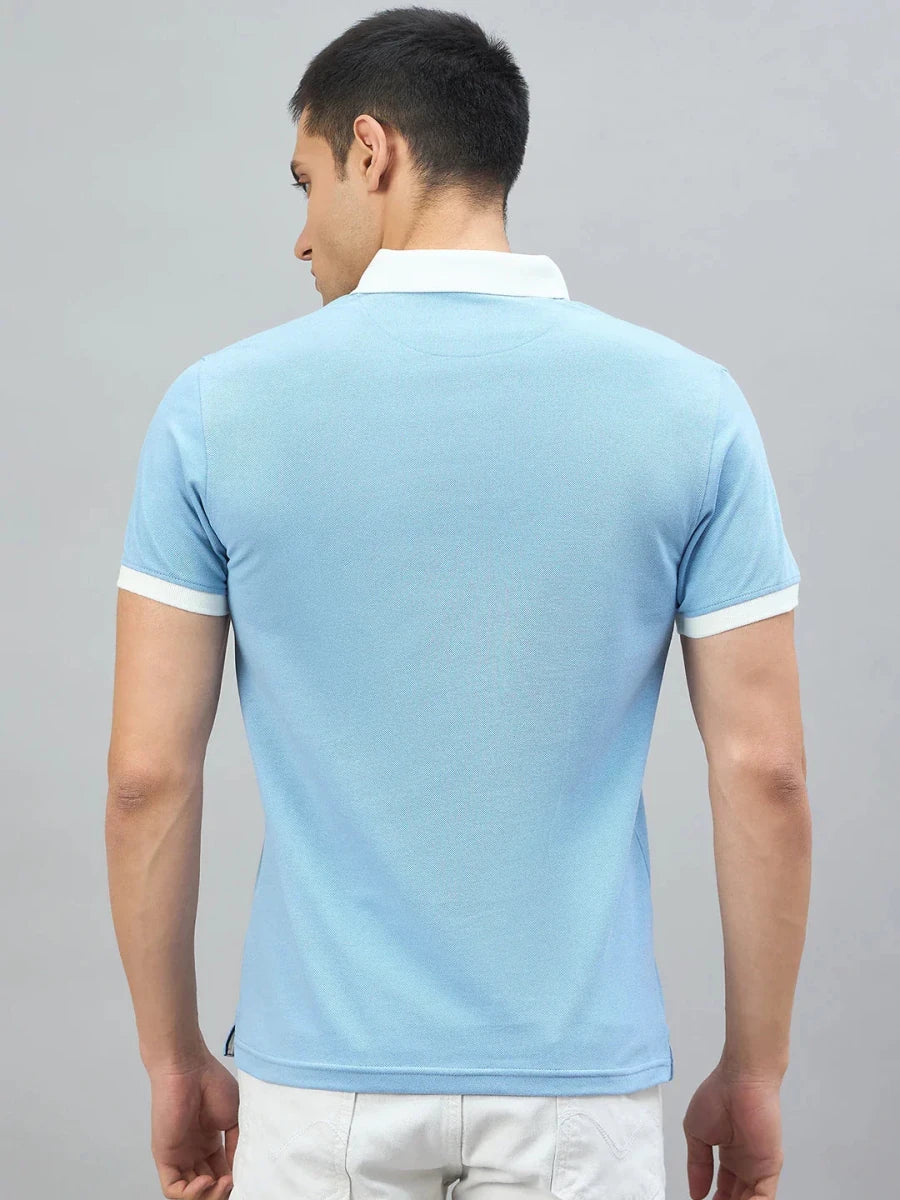 Man wears the 98degreenorth Men's Sky Blue Aeronorth KC-767A Aviation Polo T-Shirt—ideal for aviation enthusiasts.