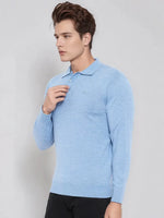 Man in 98degreenorth Men’s Sky Blue Merino Wool Polo Sweater stands against a plain light background.