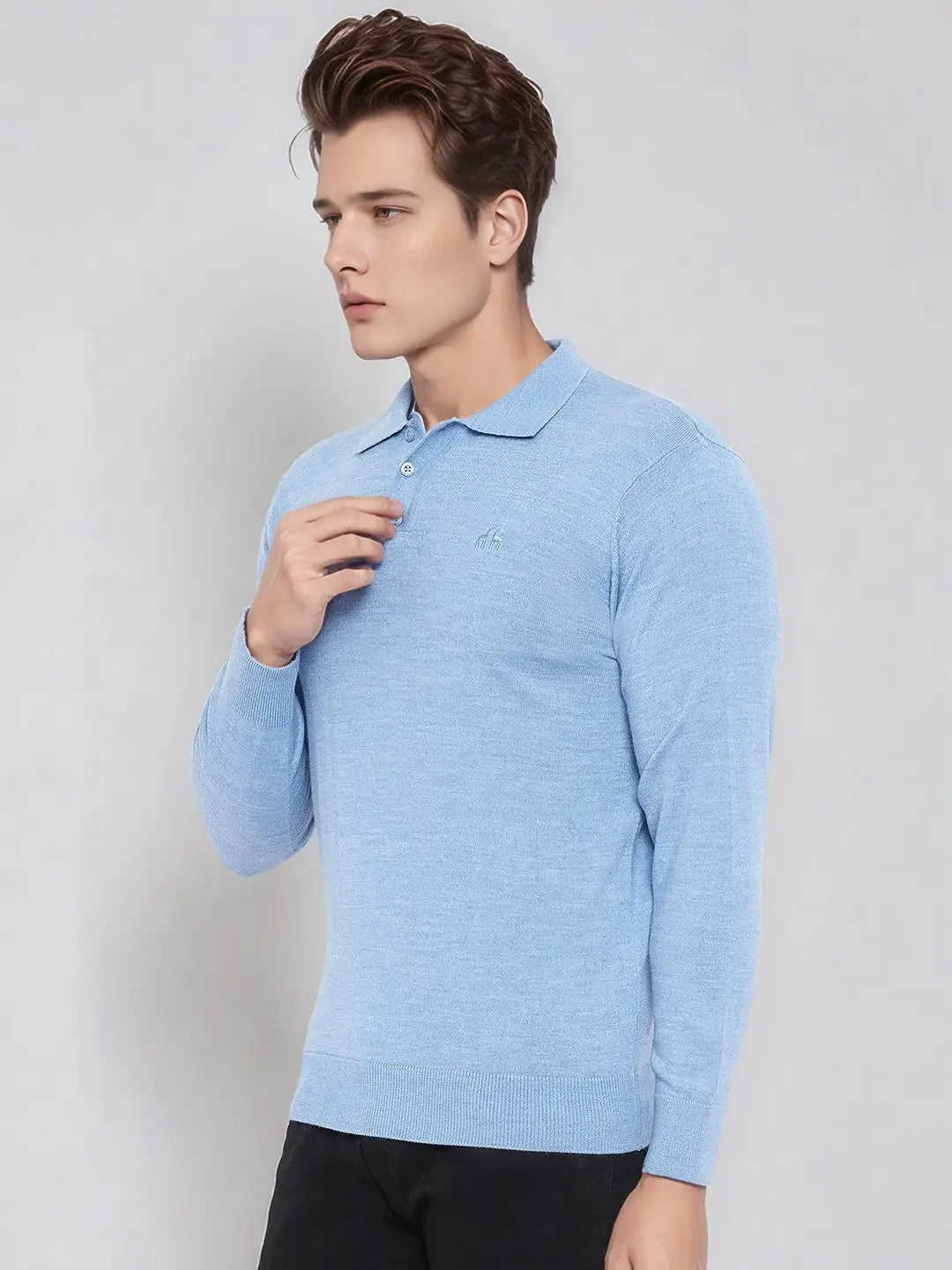 Man in 98degreenorth Men’s Sky Blue Merino Wool Polo Sweater stands against a plain light background.
