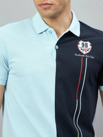 Man in a 98degreenorth sky blue & navy polo tee with Northhills Polo Club text and 98 Degree North crest.