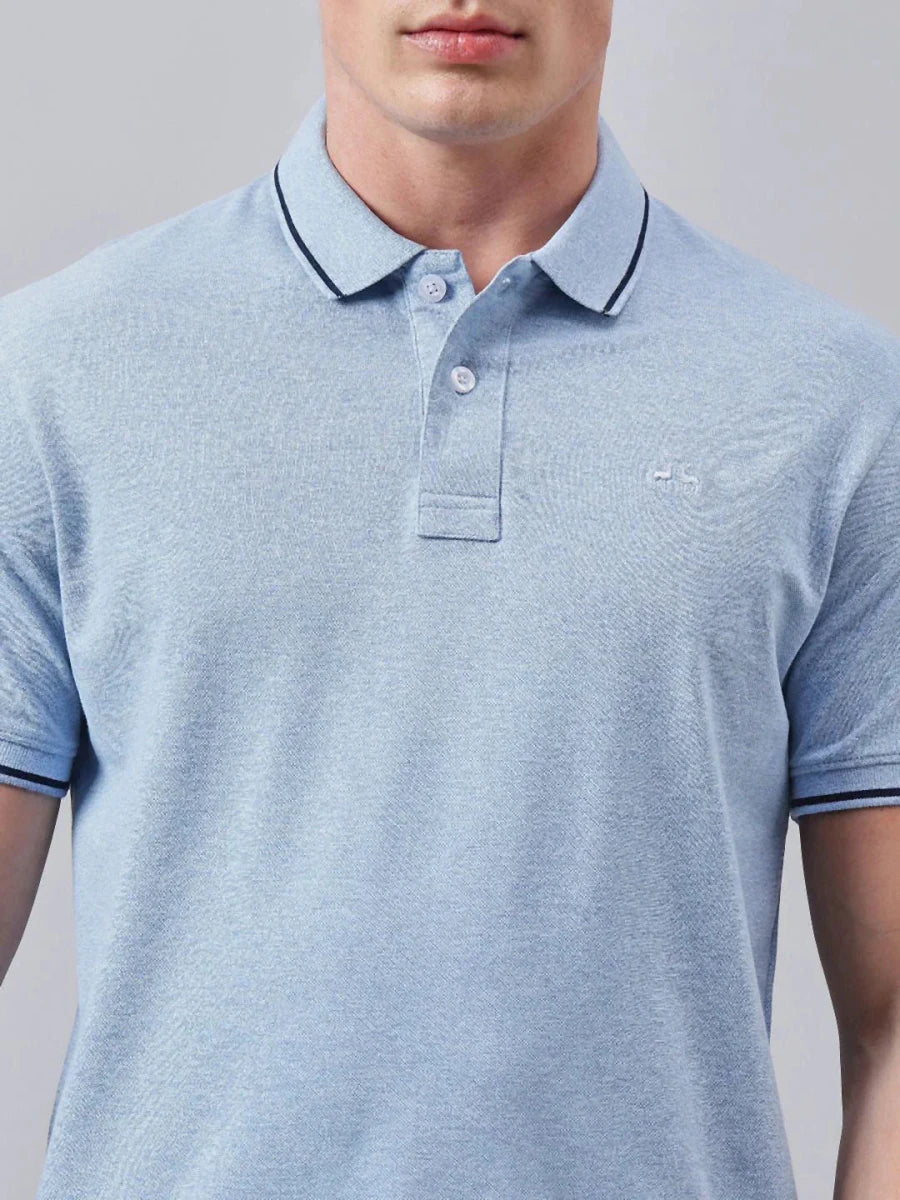 Man in a 98degreenorth Men's Sky Blue Solid Polo T-Shirt with dark-trimmed collar and sleeves, shown shoulders to mid-torso.