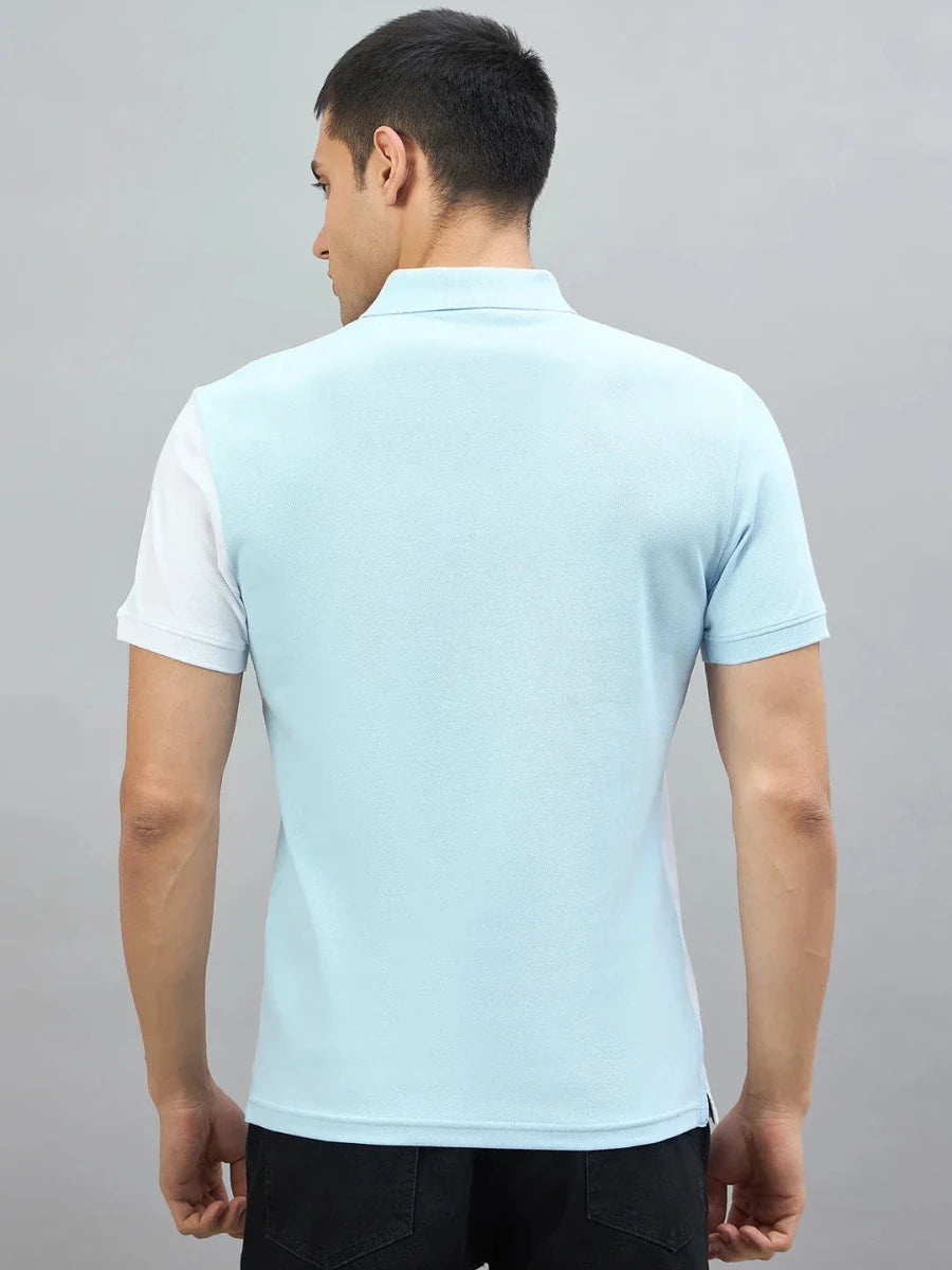 Man in a 98degreenorth Sky Blue & White Colour Block Polo T-Shirt, facing away, against a gray background.