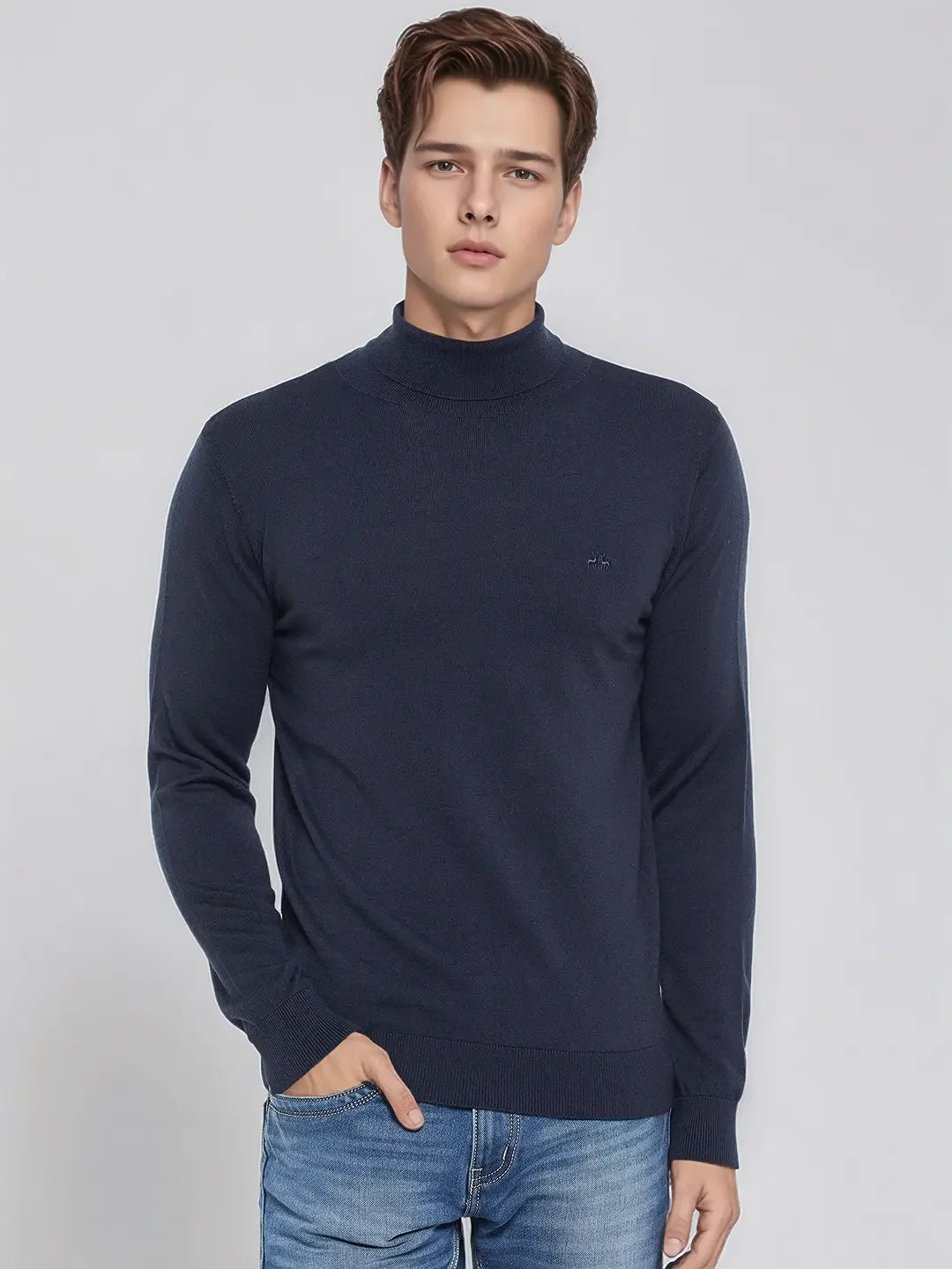 A man wears the 98degreenorth Men’s Teal Blue Merino Wool Turtle Neck Sweater against a plain light background.