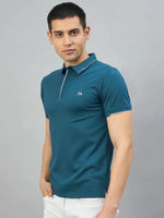 Man in 98degreenorth Men’s Teal Polo T-Shirt with White Tipping & LA logo, posed against a grey background.