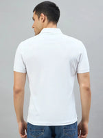 Man wears 98degreenorth Men's White AR Elite Club No.3 Polo T-Shirt and blue jeans, back view on gray background.