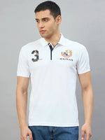 Man wearing the Men's White AR Elite Club No.3 Polo T-Shirt by 98degreenorth against a plain gray background.